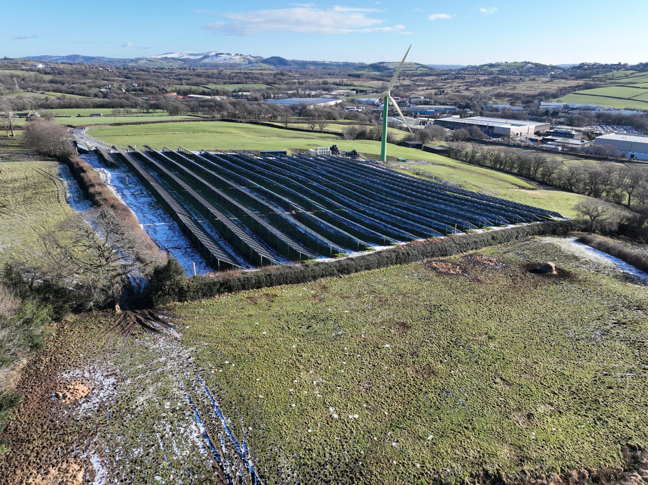 a solar panel array being built in farming land