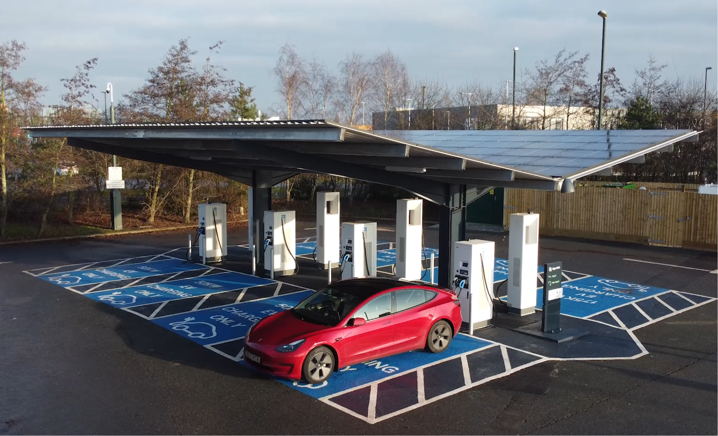 a solar carport sheltering rapid electric vehicle charging points