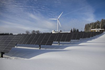 banks of solar panels in the winter snow