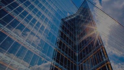 Rays of sunlight penetrate the glass facade, showcasing the effects of solar glazing in architecture.