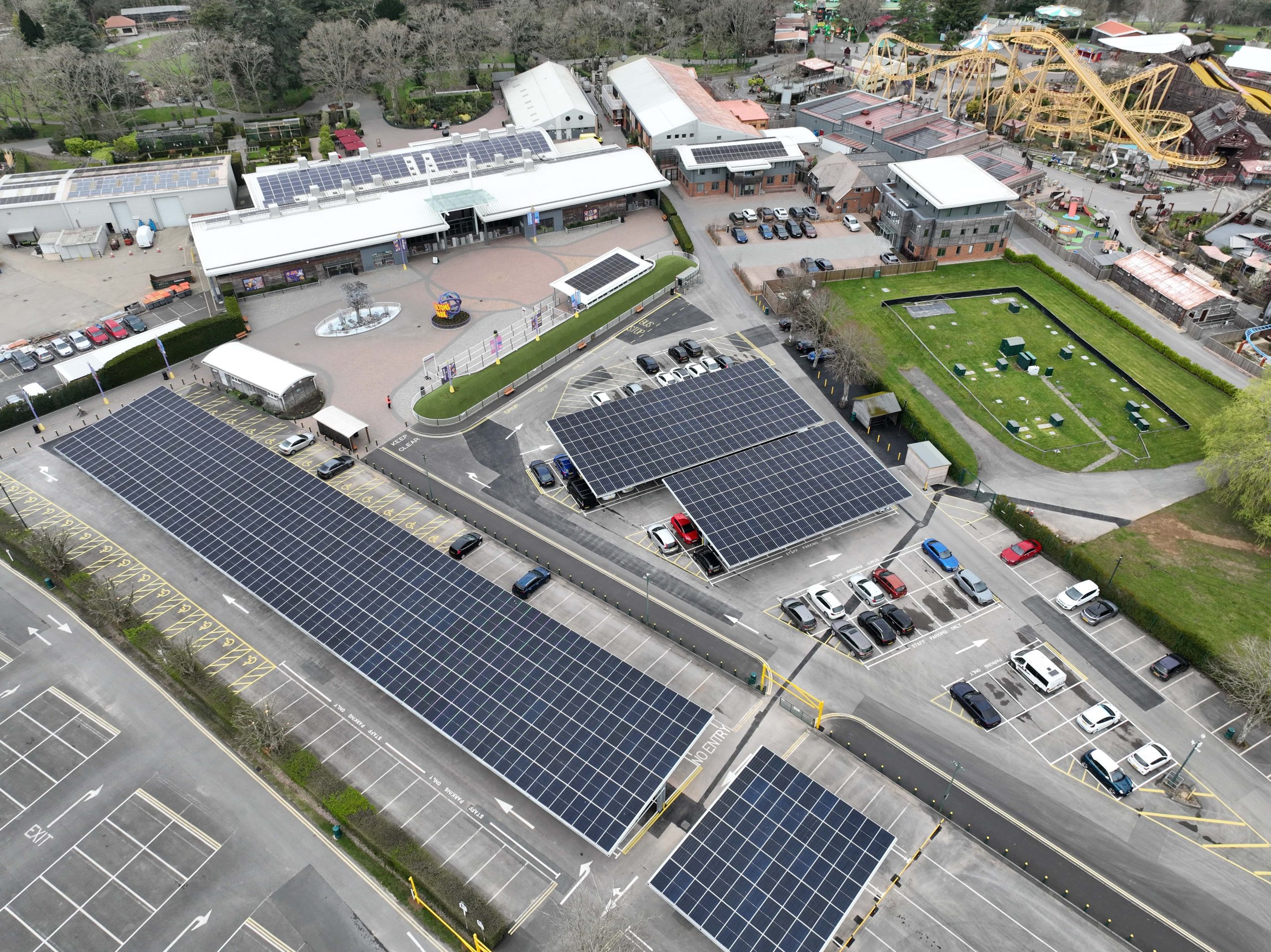 Aerial view of Paultons Park with solar panel installation across the car park and rooftops, supporting renewable energy at a leisure destination.