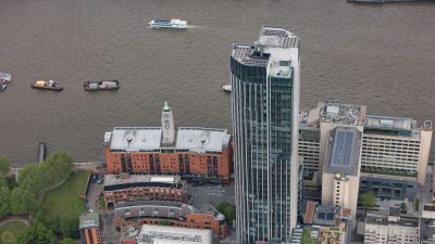 Aerial view of hotel buildings with rooftop solar panels near the River Thames