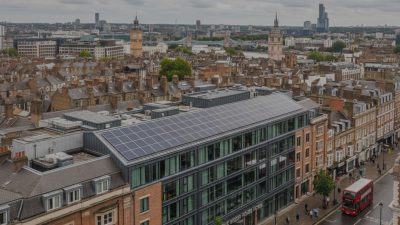 Solar panels installed on the rooftop of a modern hotel in central London